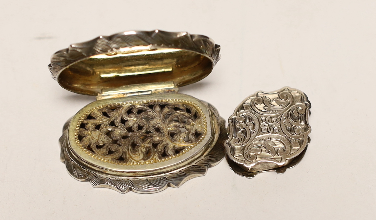 A Victorian engraved silver cartouche shaped vinaigrette, Cronin & Wheeler, Birmingham, 1846, 40mm and other other smaller silver vinaigrette, Francis Clark, Birmingham, 1840.